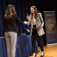 Emily shaking hands with Meghan